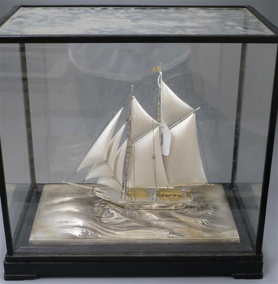 A parcel gilt sterling silver model of a sailing ship, on a stepped ebonised base, in a glazed case, case 41.5cm.